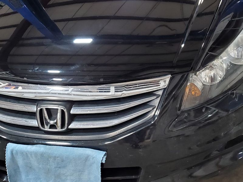The same Honda Accord after repair, the bumper and fender straight and the paint matched.