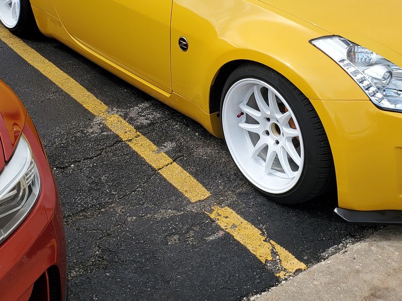 A Nissan 350Z in flat, faded yellow before a complete repaint.