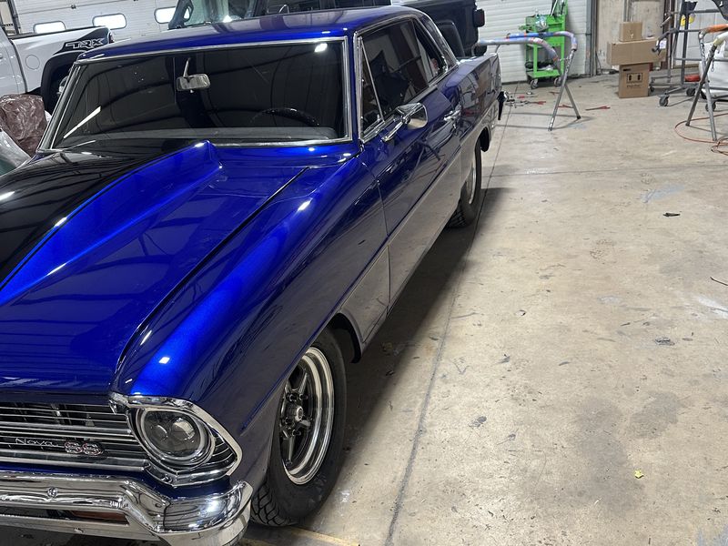 The same Chevrolet Nova after a full color change, finished in deep metallic blue.