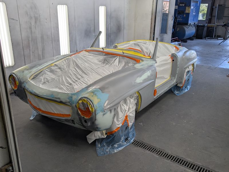 The Mercedes roadster masked up in the paint booth.