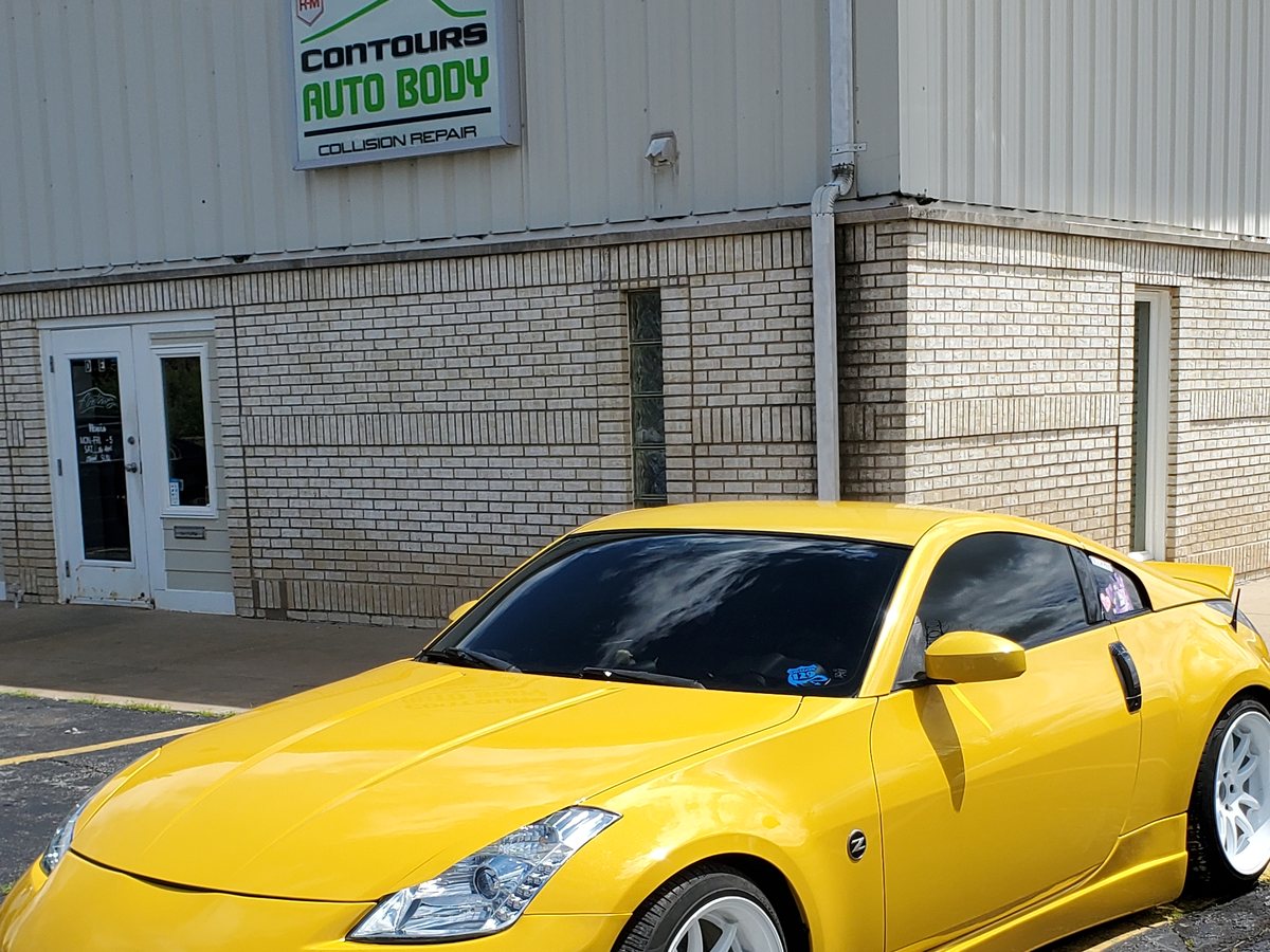 The front of the shop, with a freshly repainted car parked outside.